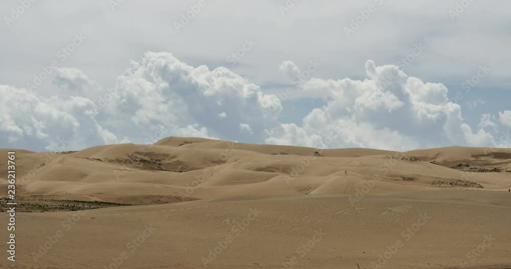 4k timelapse great white puffy cloud mass rolling over desert sand,dunes plateau landform. 4k timelapse great white puffy cloud mass rolling over desert sand,dunes plateau landform.