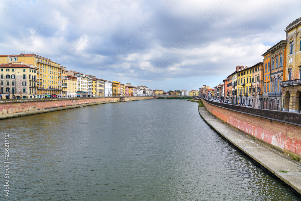 View from a bridge on embankment of Arno river. Pisa, Italy