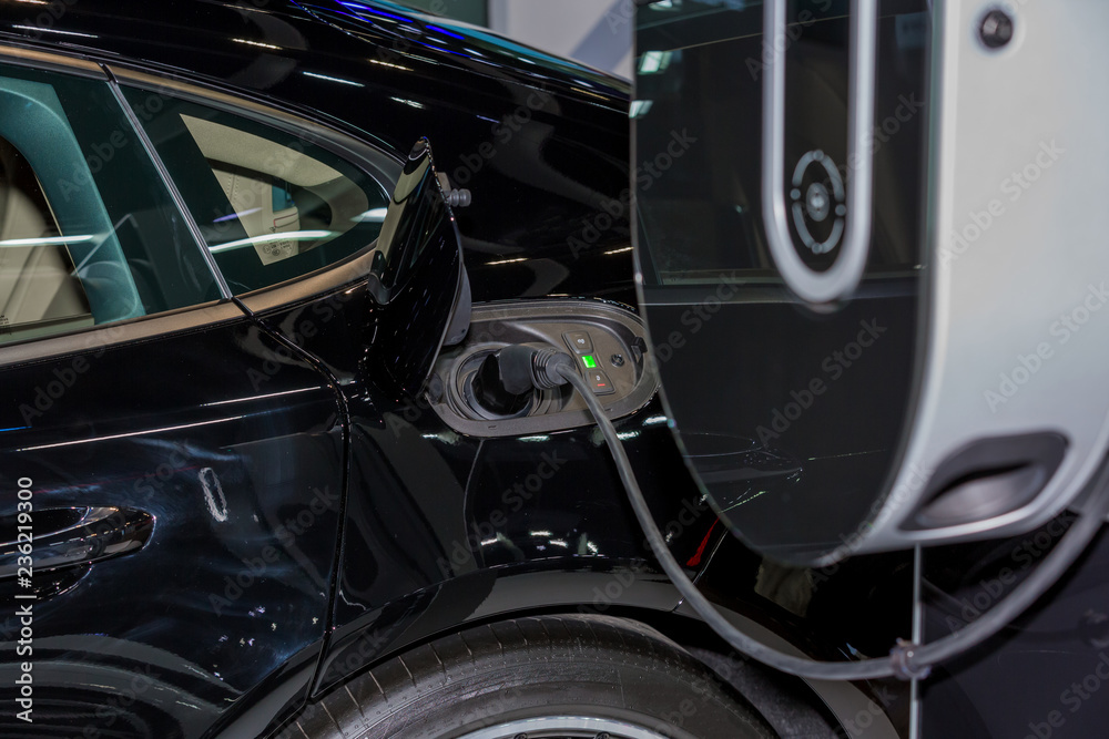 Electric car charger, The process of charging an electric vehicle. Electric car socket. Electric car charger, The process of charging an electric vehicle. Electric car socket.
