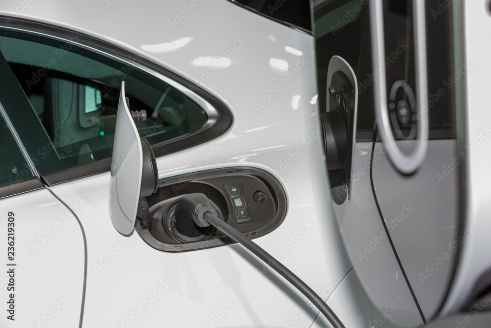 Electric car charger, The process of charging an electric vehicle. Electric car socket. Electric car charger, The process of charging an electric vehicle. Electric car socket.