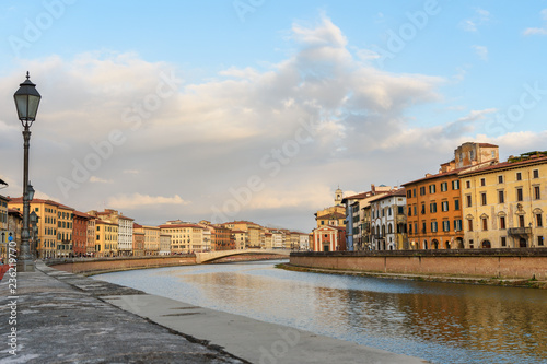 View on embankment of Arno river and bridge Ponte Di Mezzo. Pisa, Italy © Elena Odareeva