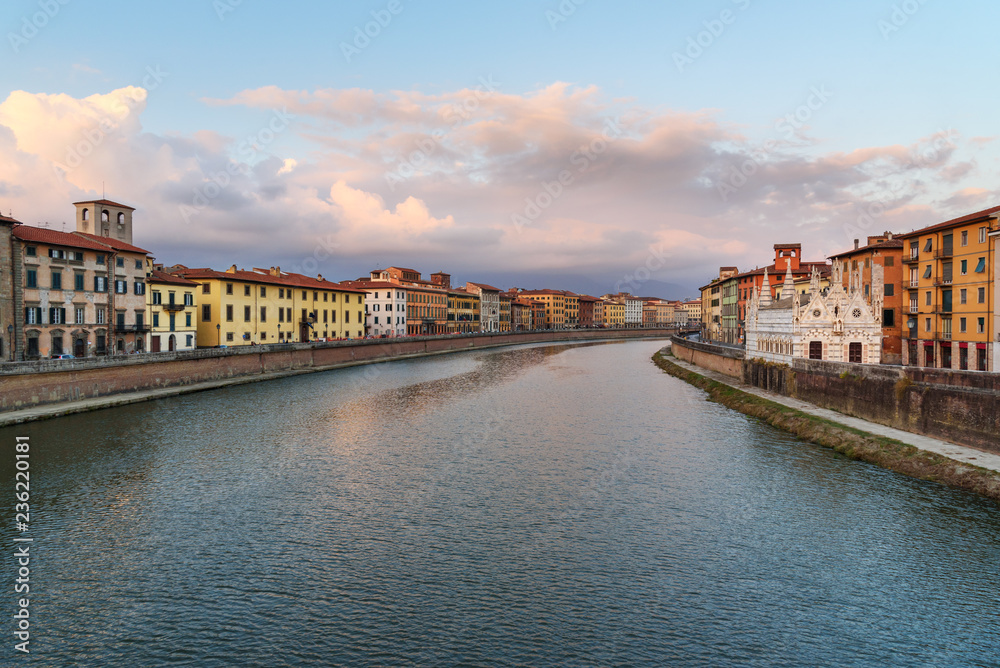 View on embankment of Arno river with Church of Santa Maria de la Spina at sunset. Pisa, Italy
