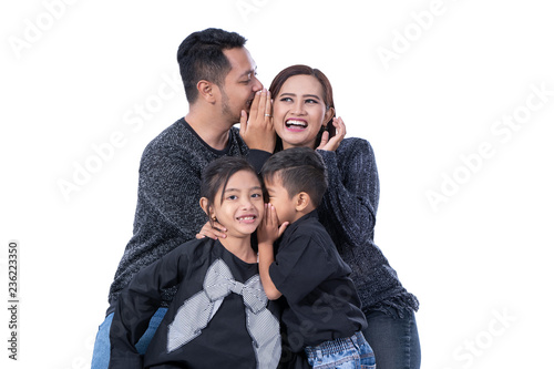 kid whispering something to parents  © Odua Images