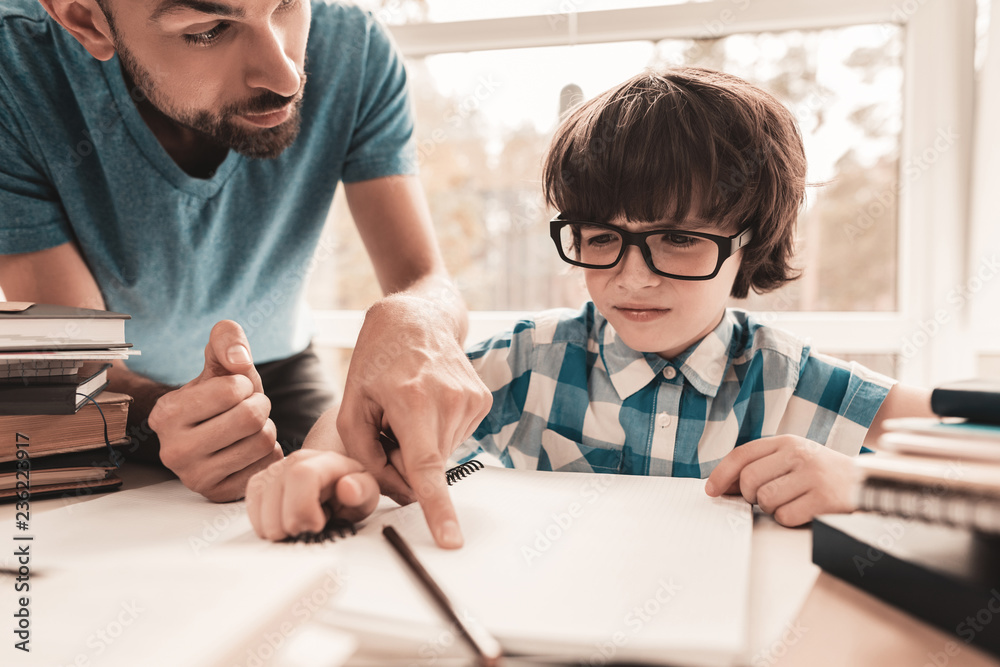 Little Boy in Glasses Doing Homework with Father. Little Boy in Glasses Doing Homework with Father.