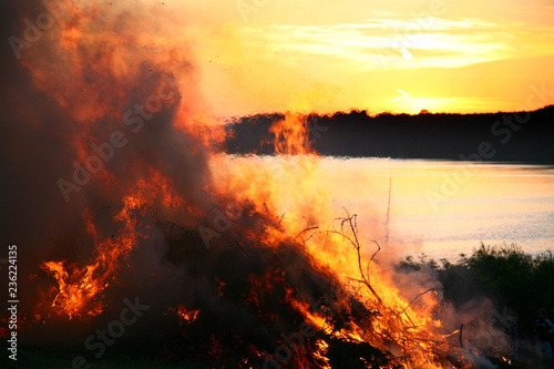 Outdoor fire nearby a lake in the summer in Denmark