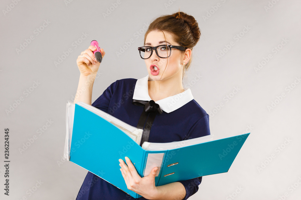 Happy positive business woman holding binder with documents Happy positive business woman holding binder with documents
