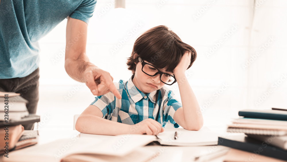 Little Boy in Glasses Doing Homework with Father. Little Boy in Glasses Doing Homework with Father.