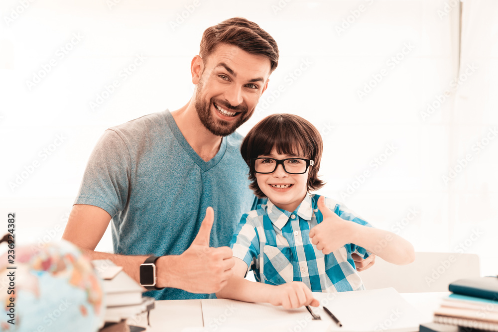Little Boy in Glasses Doing Homework with Father. Little Boy in Glasses Doing Homework with Father.