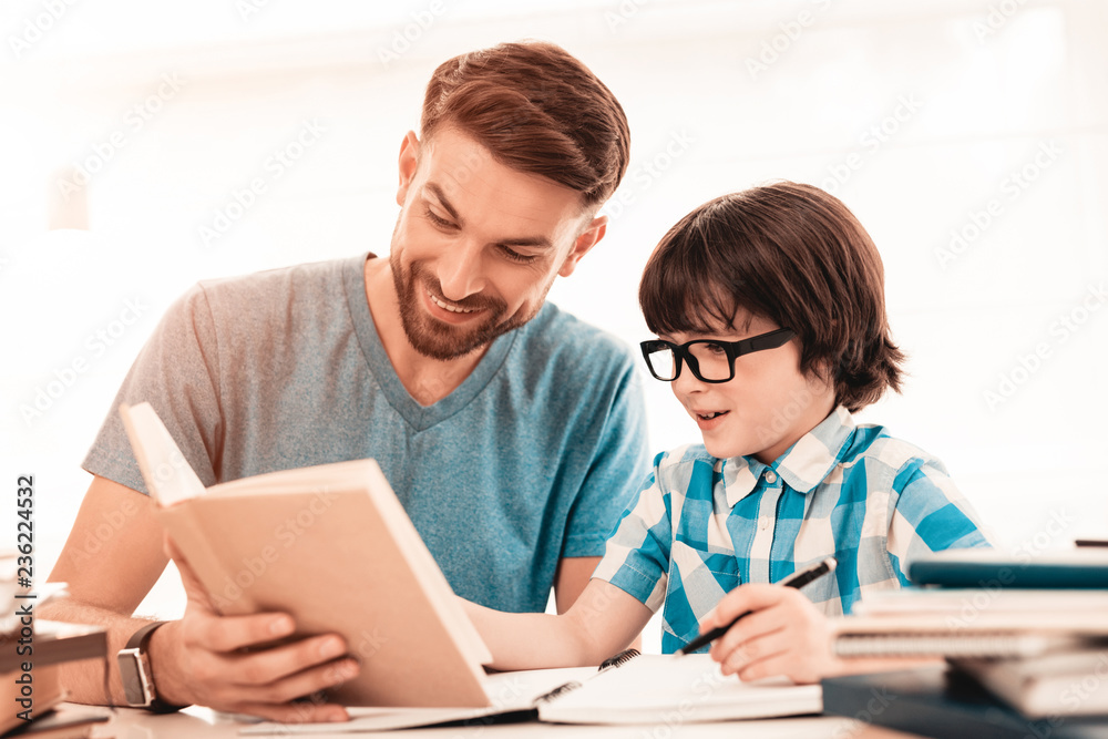 Little Boy in Glasses Doing Homework with Father. Little Boy in Glasses Doing Homework with Father.