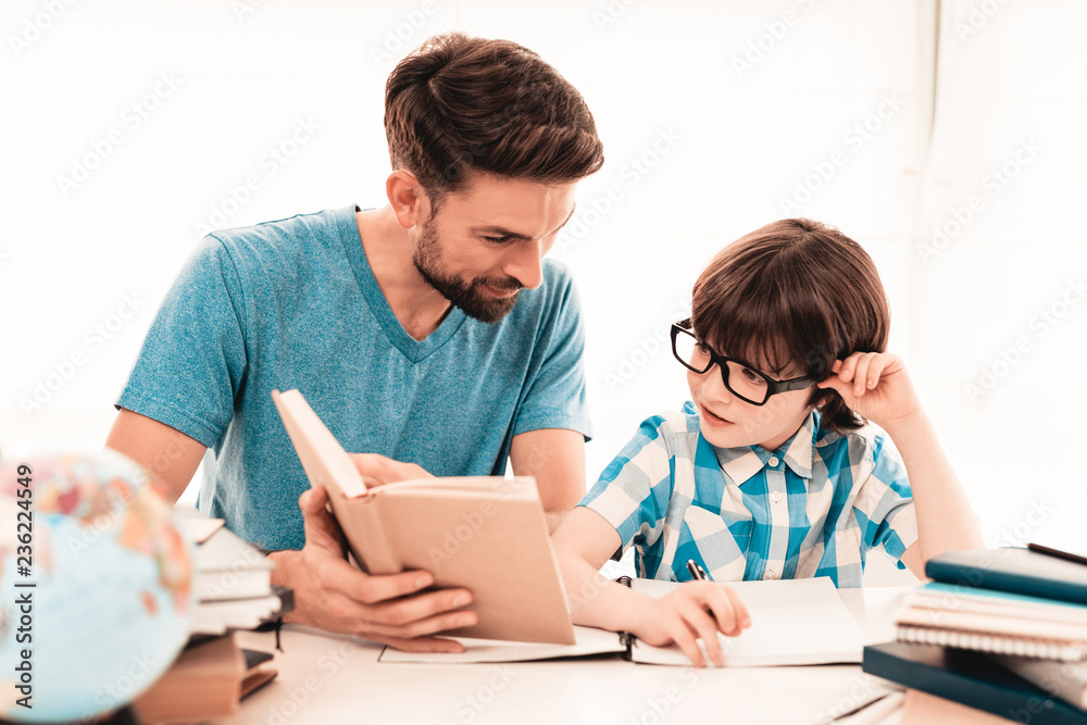 Little Boy in Glasses Doing Homework with Father. Little Boy in Glasses Doing Homework with Father.