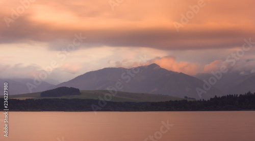Long Exposure Shot of Liptovska Mara Lake, Low Tatras Mountains and Cloudy Sky at Sunset.