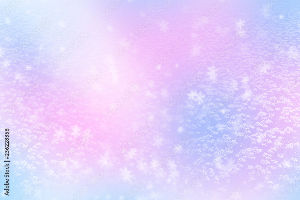 Winter shiny snowflakes blurred background in light blue pink colors. Blurry Christmas holiday background with snow flakes, frost pattern, soft flares of light. Copy space