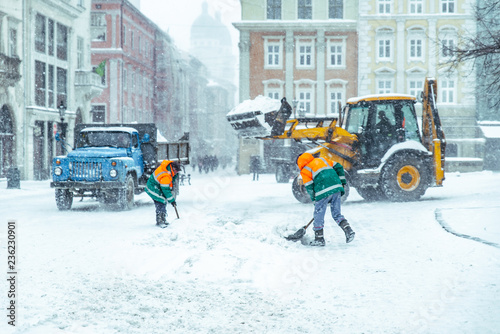 people cleaning city streets after snowstorm