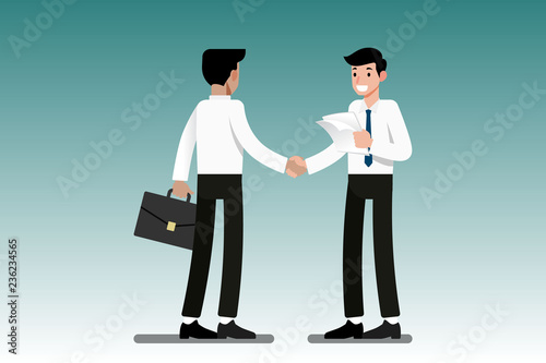 Two Businessmen standing and shake hands each other for cooperation and make a deal.
