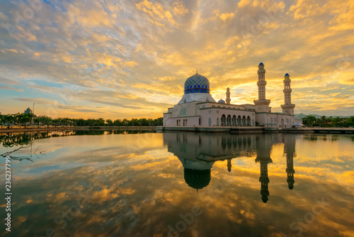 Dramatic fiery cloud on the sky and its reflection on the lake during sunrise captured at the beautiful floating mosque at Kota Kinabalu, Sabah, Malaysia. photo