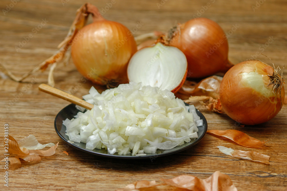 Onion and onion sliced on a rustic wood table. Close-up photo of healthy food.