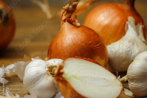 Garlic and onion on a wooden table. Close-up photo of healthy food.