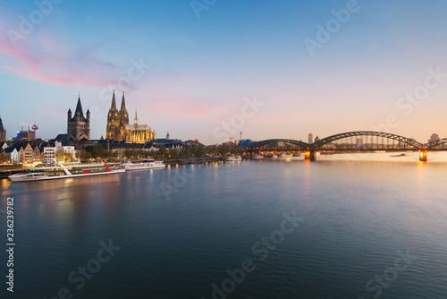 Image of Cologne with Cologne Cathedral with Rhine river and Hohenzollern bridge during twilight blue hour in Germany.