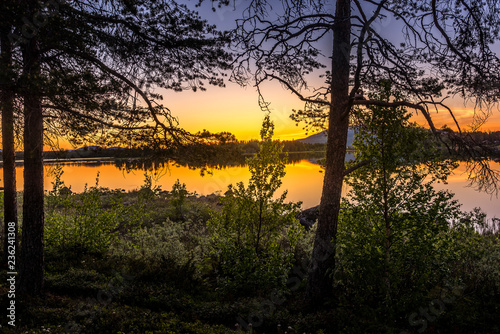 Midnight sun over a lake in Arjeplog, Sweden photo