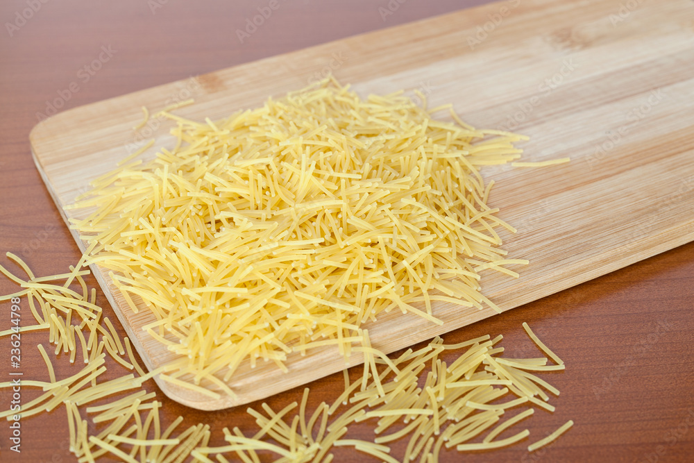 Vermicelli on a wooden kitchen board. Vermicelli on a wooden kitchen board.