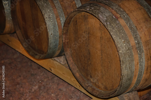 Old oak wine barrel in wine cellar, this type of barrel used as traditional aging methods in winemaking.