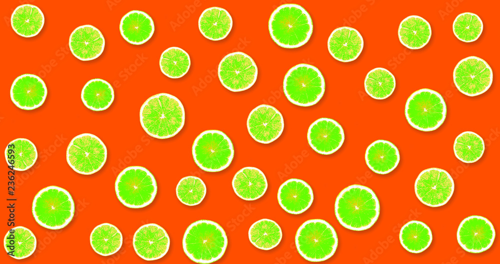 Background with green, fresh lemons on a red, strawberry background