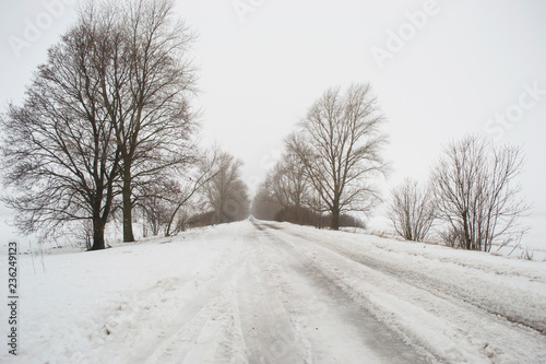 Snowy weather on the empty road, danger, winter. © vitusia
