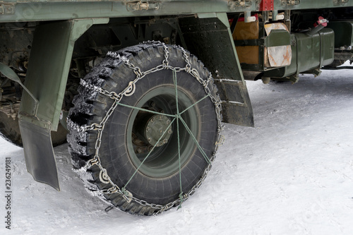 Snow chains on tires truck in the winter for safe drive on snowy roads. Protect to slip and easy to control the vehicle