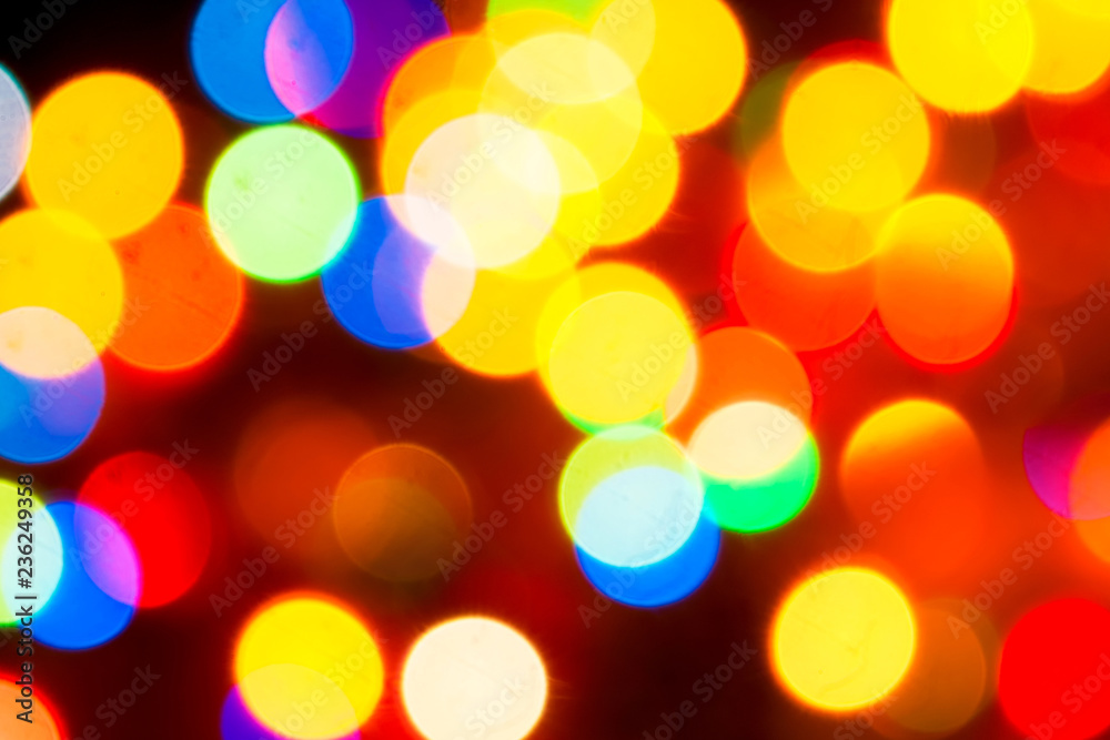 Fototapeta premium Christmas lights. Blurred festive background for a New Year's design. Winter holidays. Bokeh. Bright juicy colors.