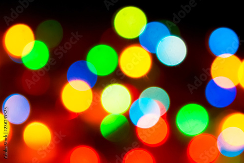 Christmas lights. Blurred festive background for a New Year's design. Winter holidays. Bokeh. Bright juicy colors.