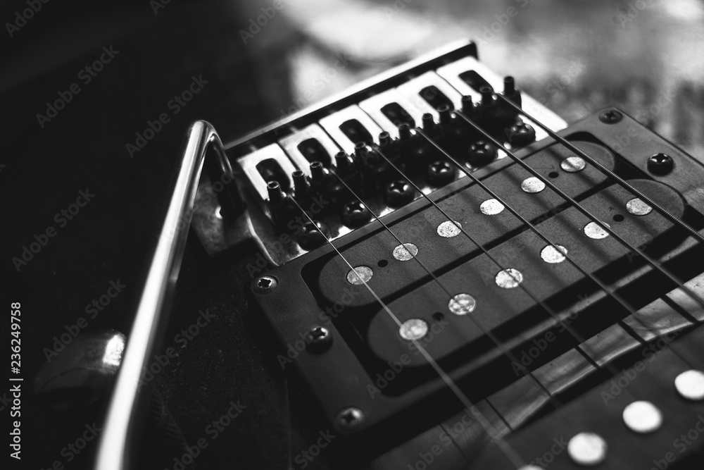 red electric guitar strings isolated on black background, closeup, black and white red electric guitar strings isolated on black background, closeup, black and white