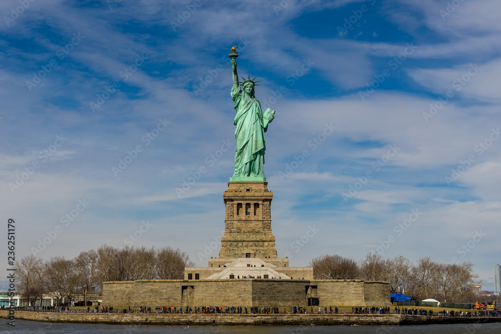 Front view of The Statue of Liberty on Liberty island with blue sky background, Landmarks of New York City, USA
