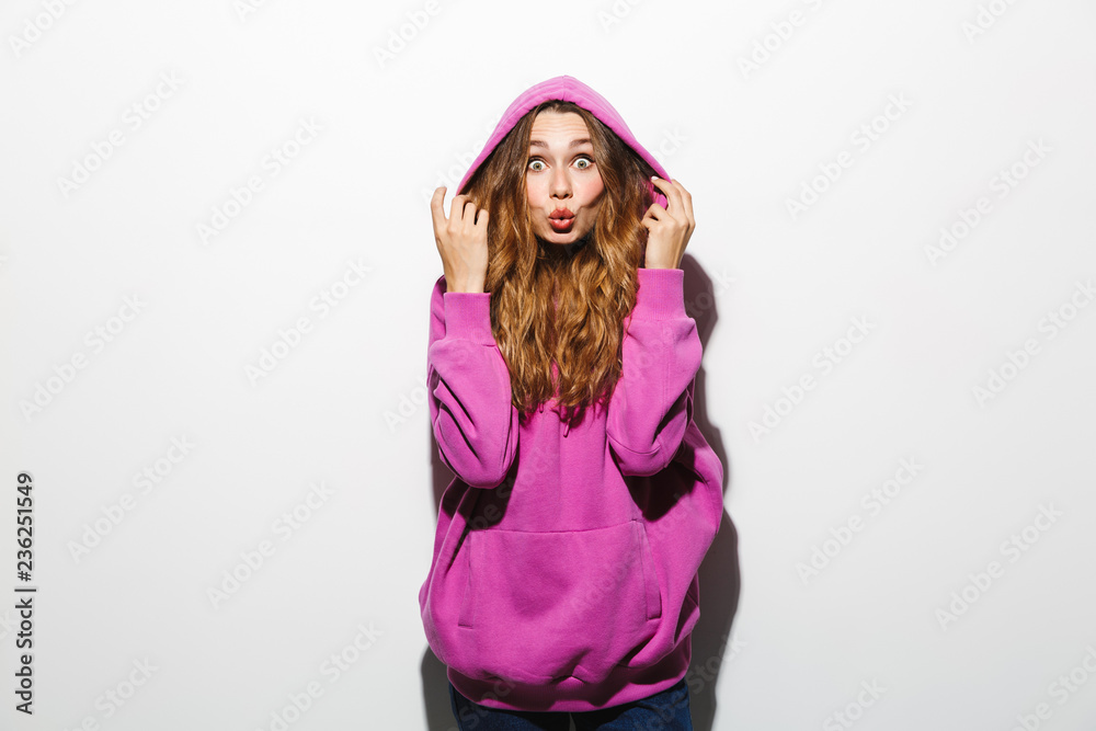 Image of stylish woman 20s wearing sweatshirt smiling, isolated over white background Image of stylish woman 20s wearing sweatshirt smiling, isolated over white background