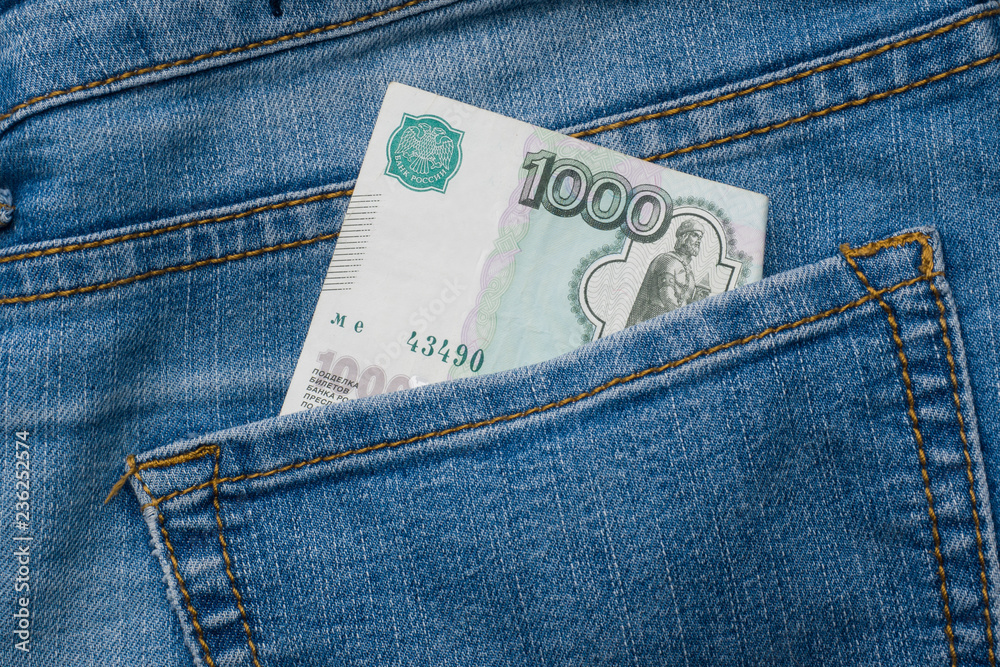 Jeans pocket with banknotes of one thousand Russian rubles Jeans pocket with banknotes of one thousand Russian rubles