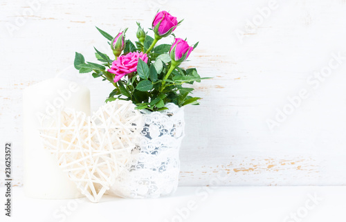 Fototapeta Naklejka Na Ścianę i Meble -  Decorative heart, pink roses and candles on white wooden backgro