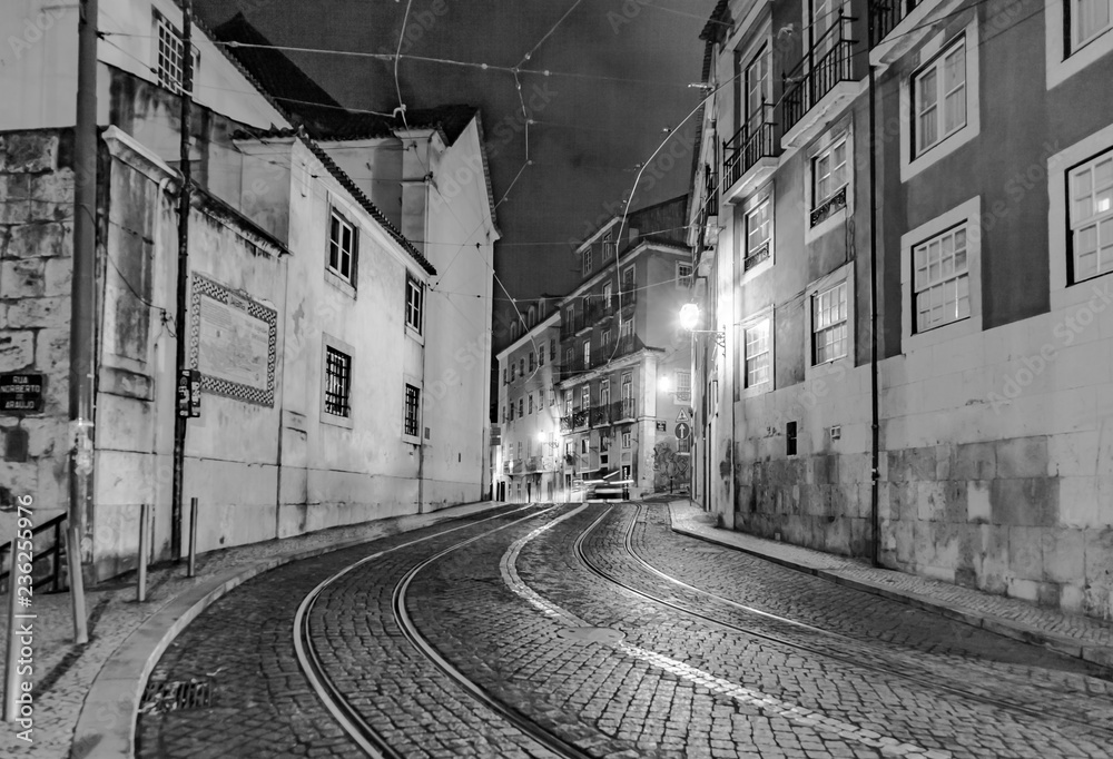 streetcar rails in the old part of Lisbon by night