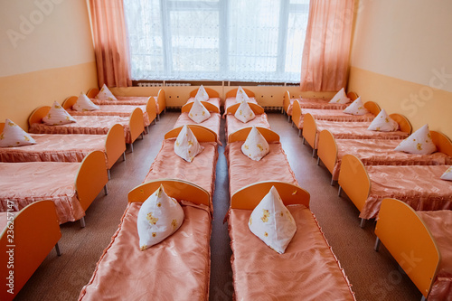 Cots in the kindergarten. Orphanage or boarding school. Beds in a boarding school or in an orphanage photo