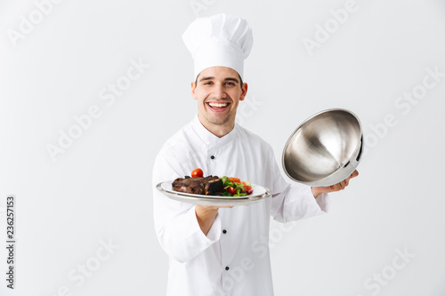 Excited man chef cook wearing uniform photo