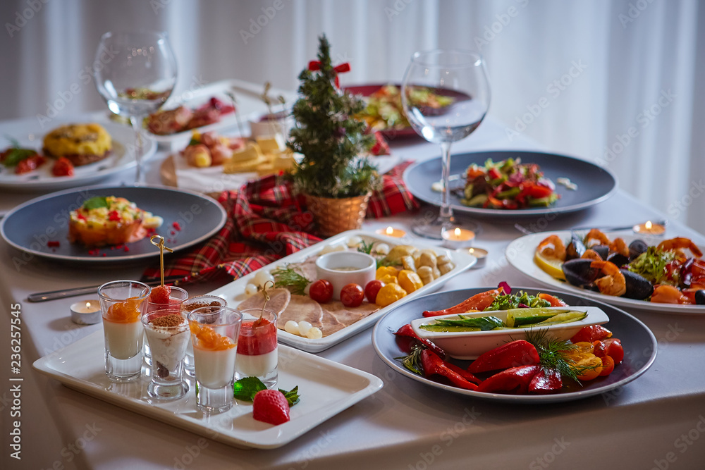 Beautifully served table in a restaurant with lots of salads, appetizers, desserts Beautifully served table in a restaurant with lots of salads, appetizers, desserts