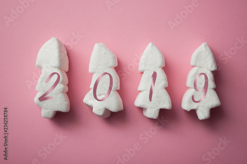 greeting 2019 card with white marshmallows in shaped fir on pink background