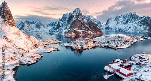 Aerial view of fishing village in surrounded mountain on winter season photo