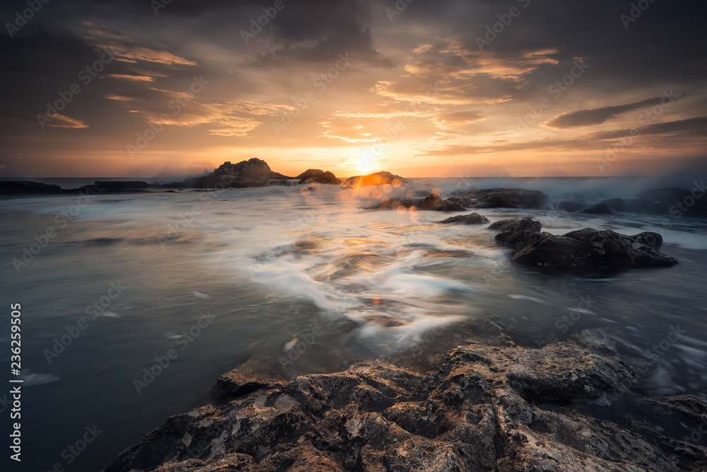 Sunrise on a rocky beach / Magnificent sea sunrise at the rocky Black sea coast