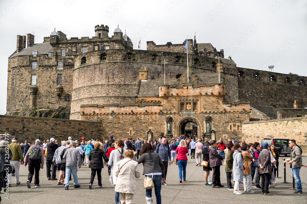 Fototapeta premium Tourists walking in front of Edinburgh Castle in Scotland – historic landmark and popular travel destination