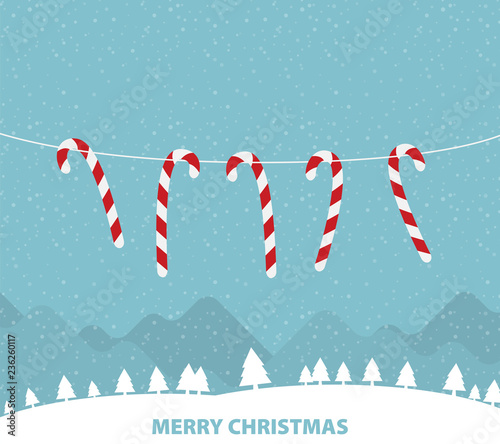 Hanging candy canes in snowy winter scene