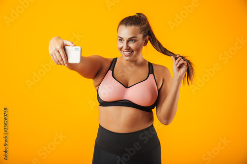 Portrait of a cheerful overweight fitness woman