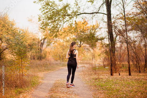 Woman running in autumn fall forest. Healthy lifestyle