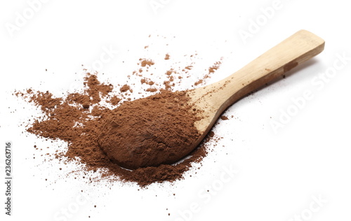 Cocoa powder pile with wooden spoon isolated on white background