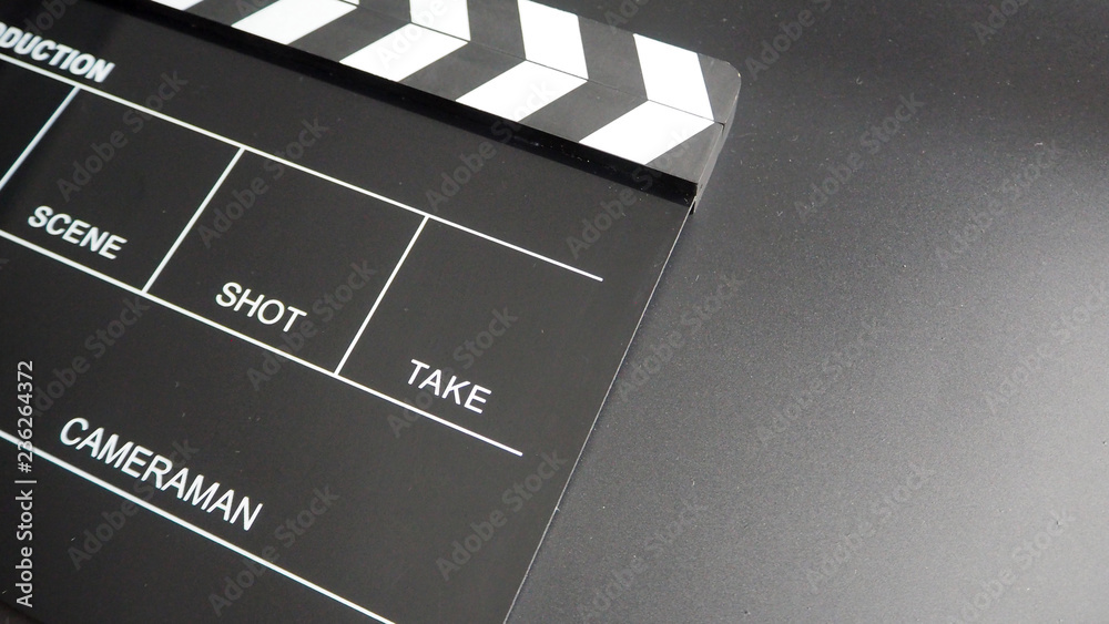 Clapper board or movie slate or clap ิboard. that use in video production , movie, film and cinema industry. It's black color on black background.