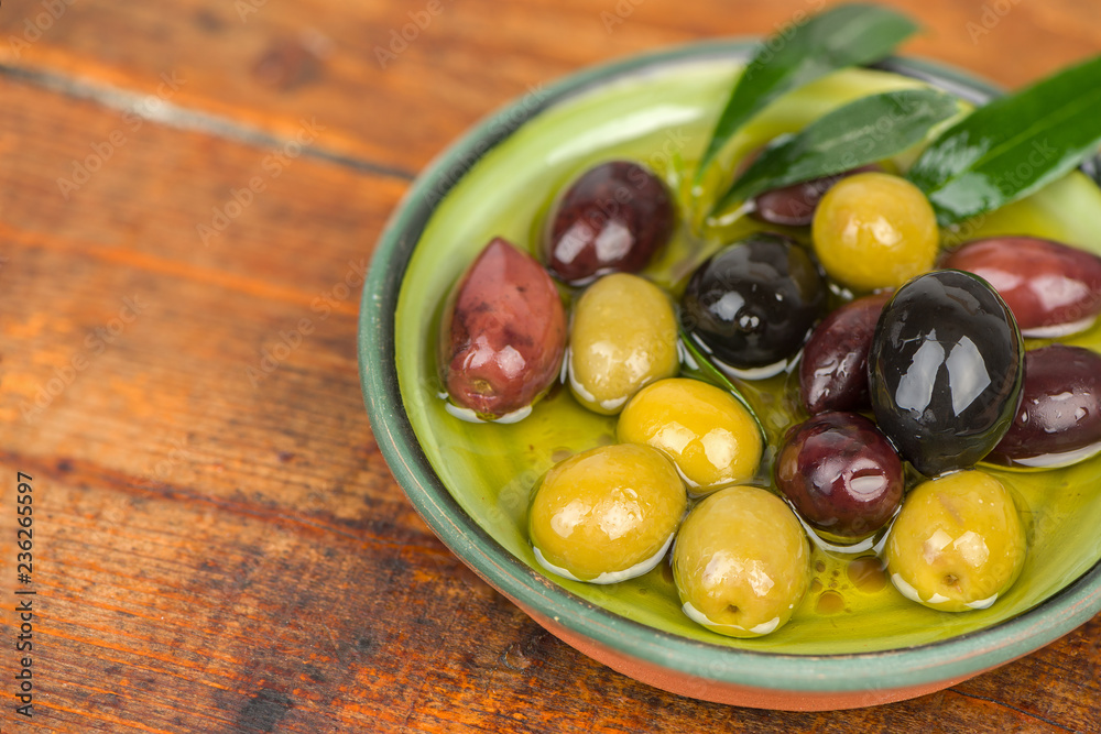 Olives in oil on wooden table. Olives in oil on wooden table.