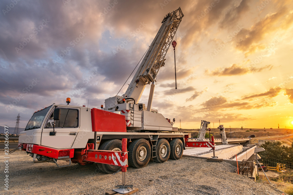 Crane trucks in the construction of a bridge Crane trucks in the construction of a bridge